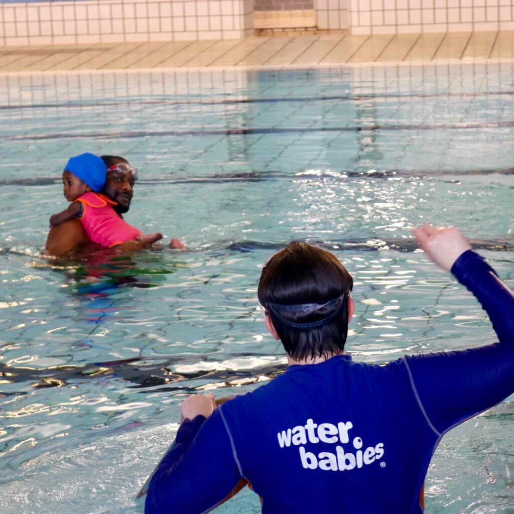david and his daughter with their water babies teacher