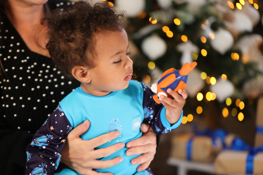 water babies toddler with smooch the fish at christmas