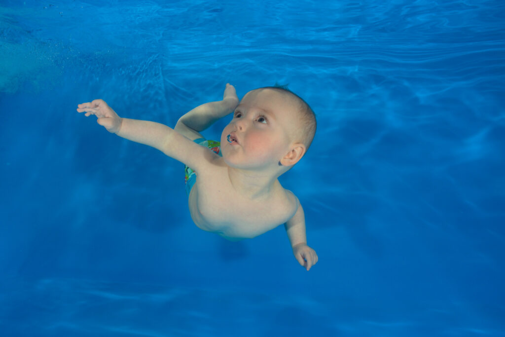 baby logan underwater at a water babies photoshoot