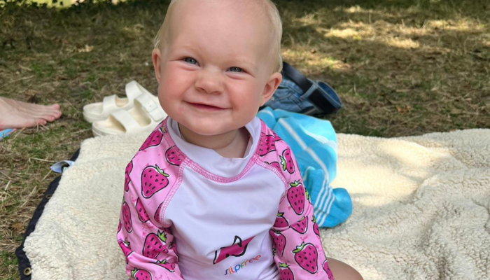 Baby sat in slipfree clothing and shoes