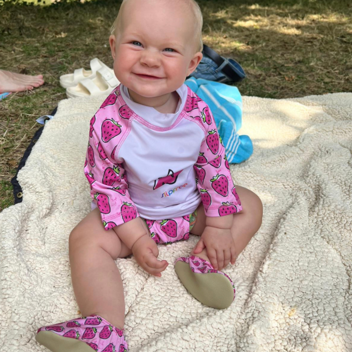 Baby sat in slipfree clothing and shoes