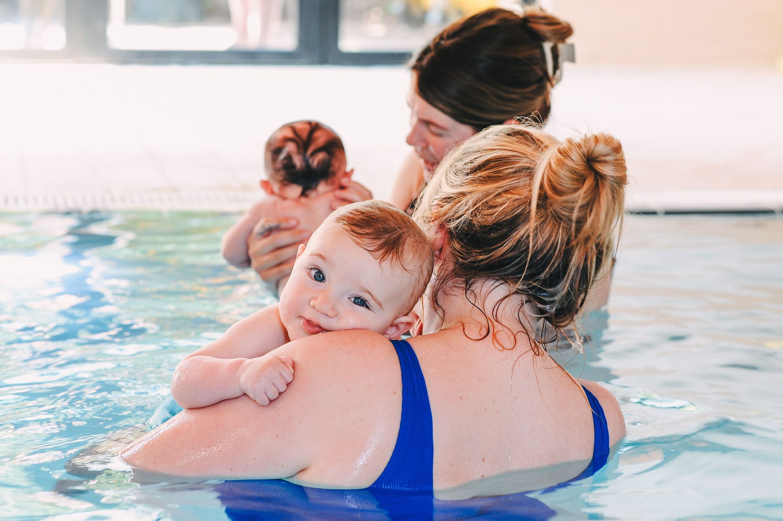mum and baby boy cuddling in water babies lesson