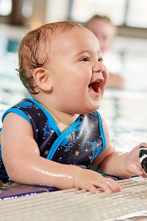 water babies baby holding on to poolside