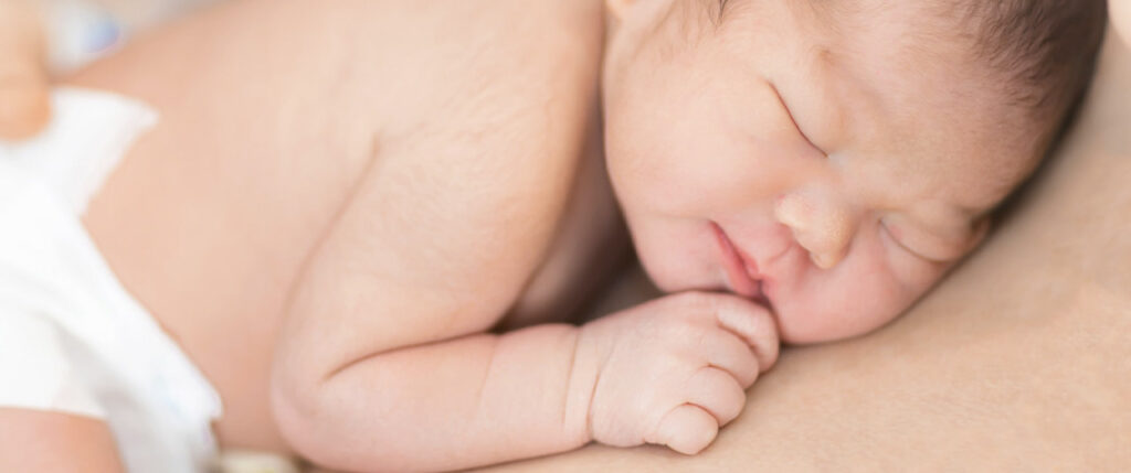 baby asleep with carer and skin to skin contact