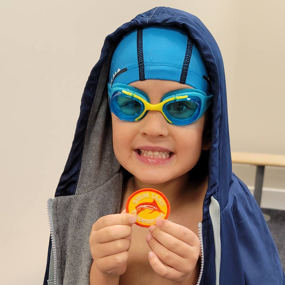 water-baby-winston-holding-up-swimming-medal