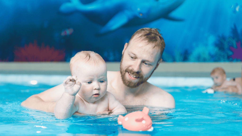 dad and baby swimming in the pool with water babies fish