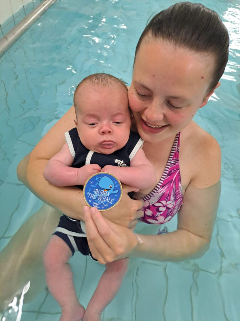 water babies mum and charlie risby with bubba badge in water babies lesson
