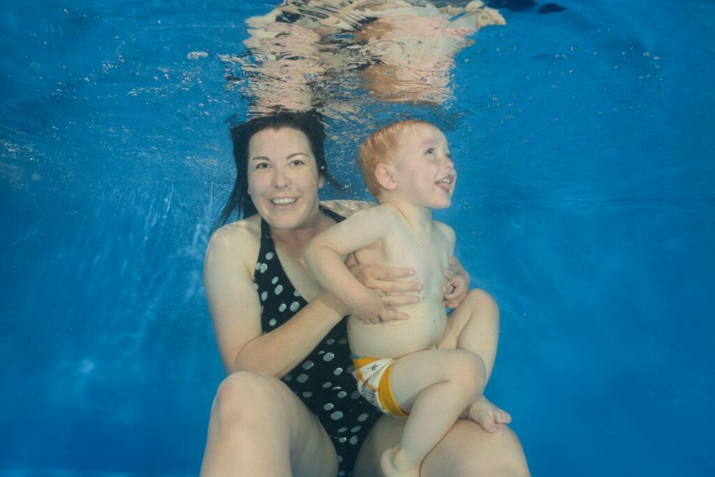 Water Babies Teacher Jess and her little boy Logan gliding through the water together.
